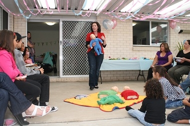 Image of Mary Dawes presenting infant first aid at a baby shower